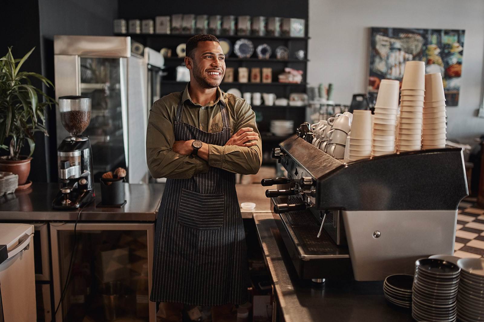 Two business owners smiling with arms crossed.